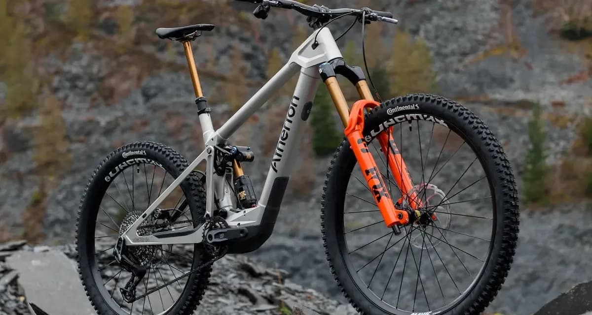 Silver Atherton enduro e-MTB with the DJI Avinox motor and orange fork on a rocky slope