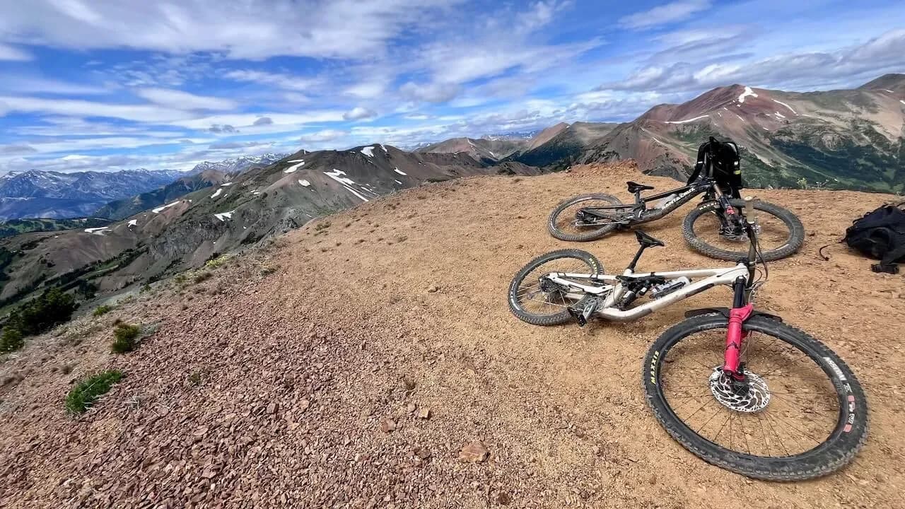 Due bici appoggiate in cresta con le montagne dei South Chilcotins sullo sfondo